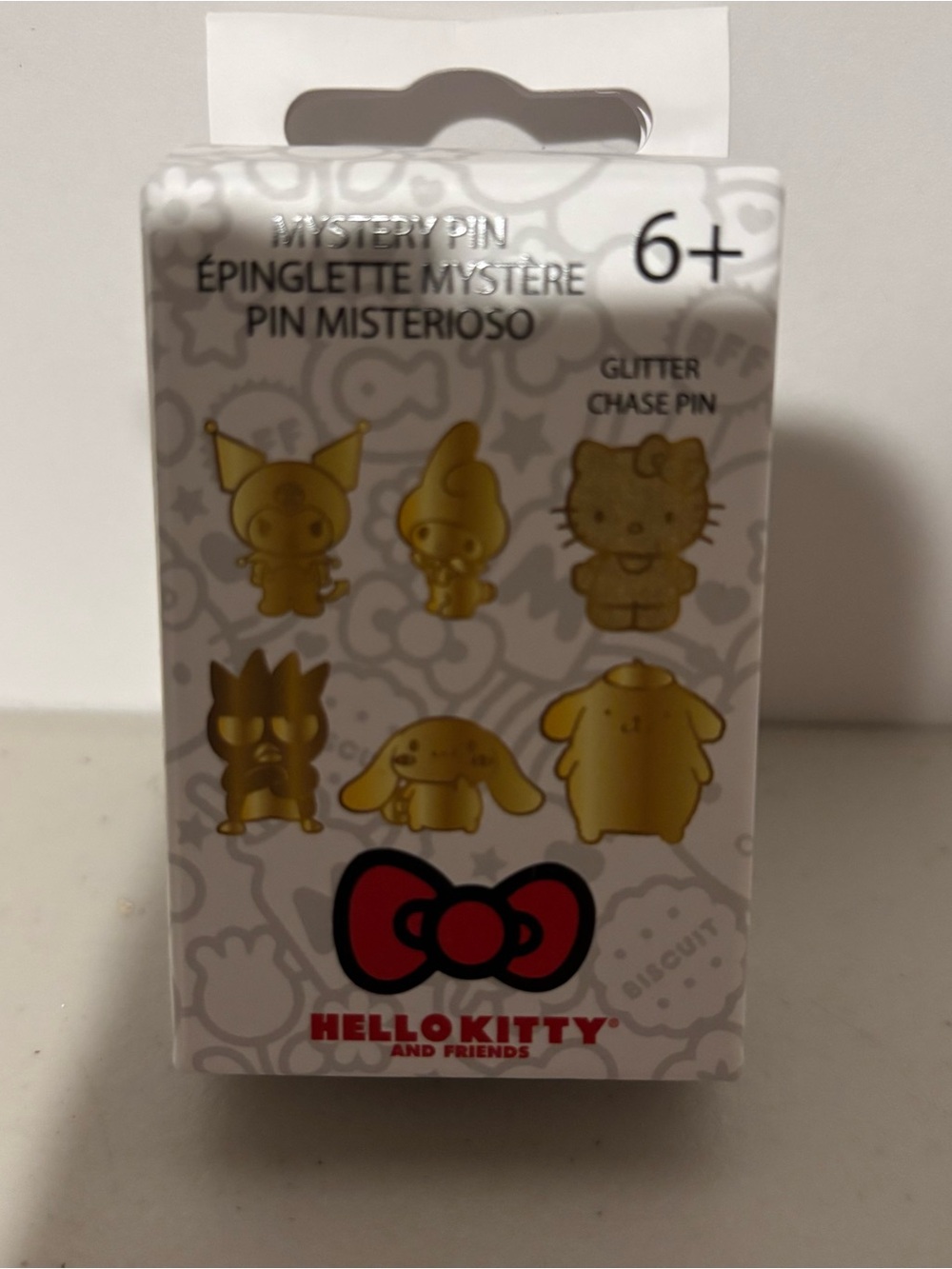 Hello Kitty Gold Accent Mystery Pin Pack with Red Bow Logo